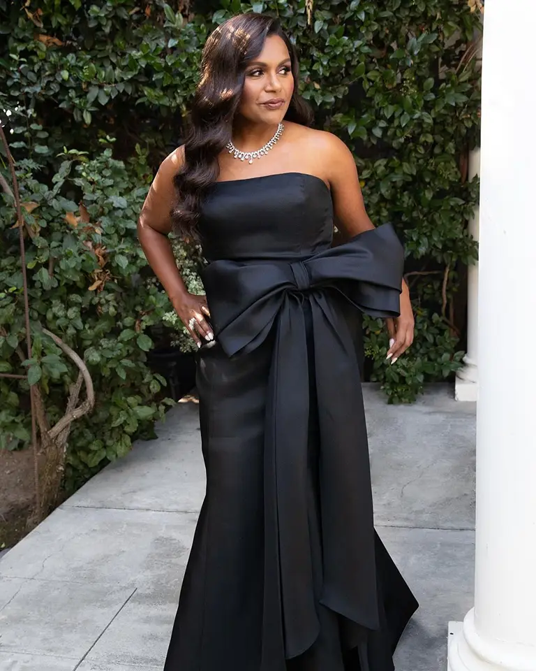 Outside in a stunning black dress.