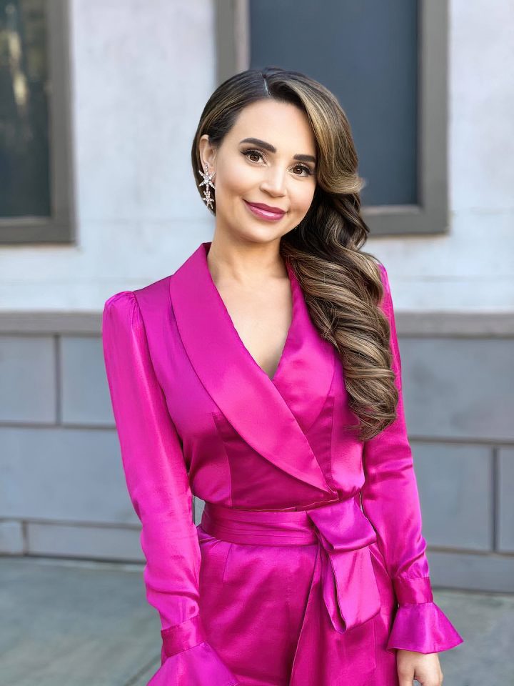 Rosanna Pansino posing in an expensive pink outfit