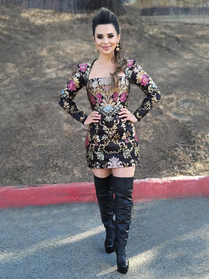 Posing in a short dress with thigh high black boots